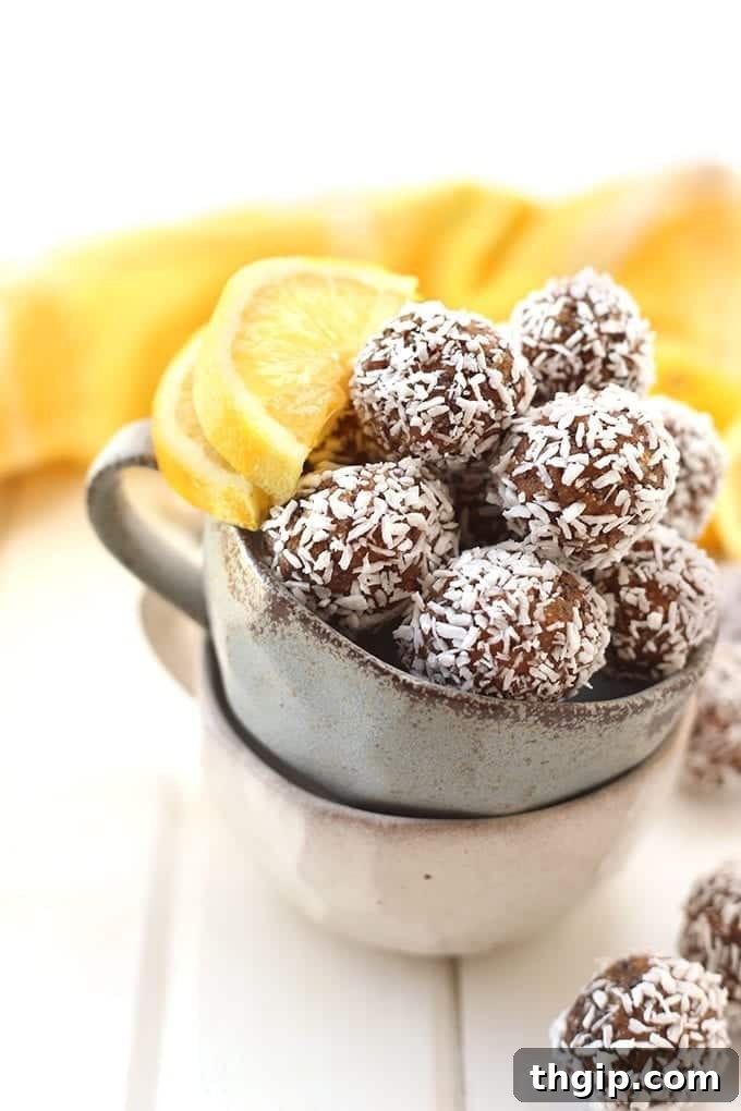 Zesty Coconut Energy Bites 3 A close-up of a stack of freshly made Lemon Coconut Chia Energy Balls, highlighting their texture and appealing coating, emphasizing their deliciousness as a healthy snack option.