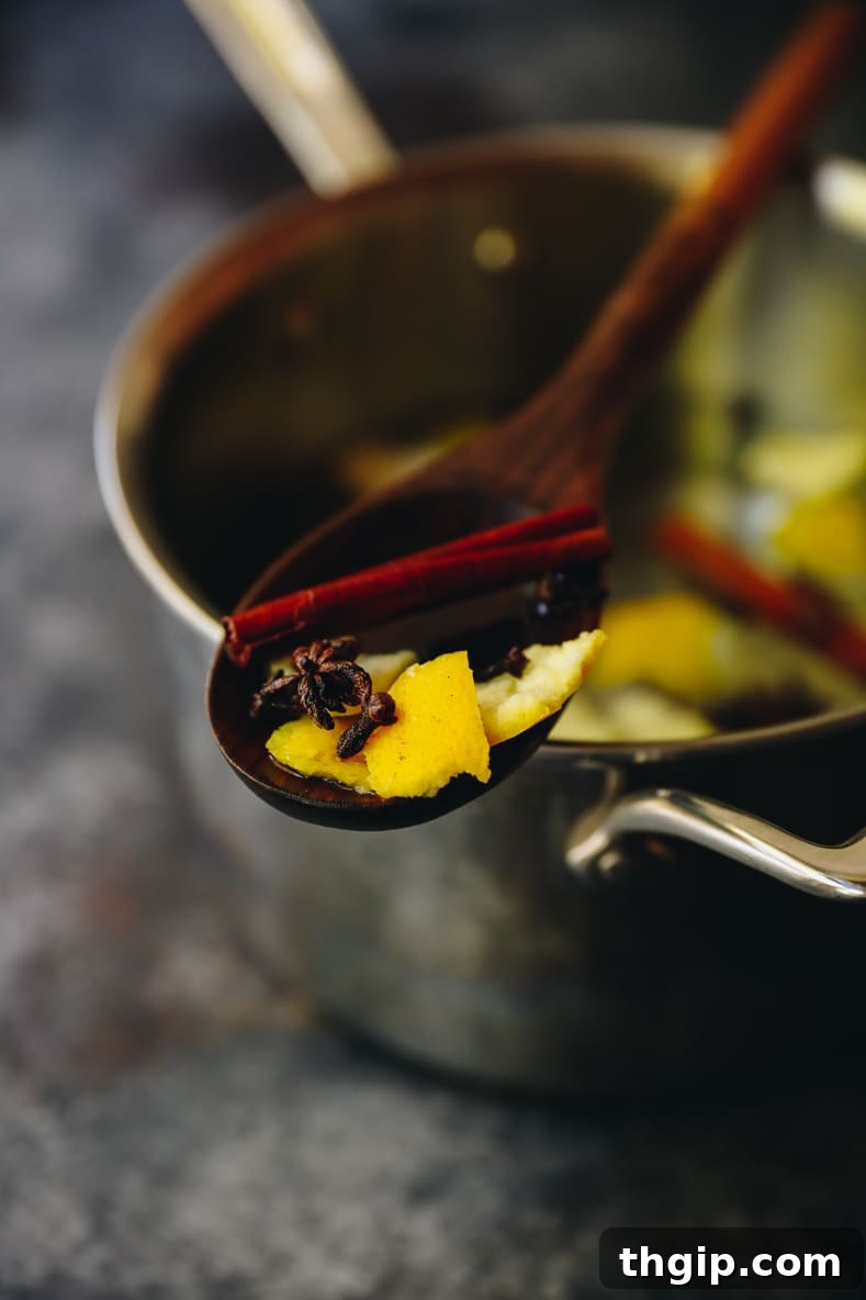The Scent of Fall: Easy Simmer Pot Spices 4 A close-up of fall simmering spices bubbling gently in a pot on the stove, releasing a warm fragrance and creating a cozy ambiance