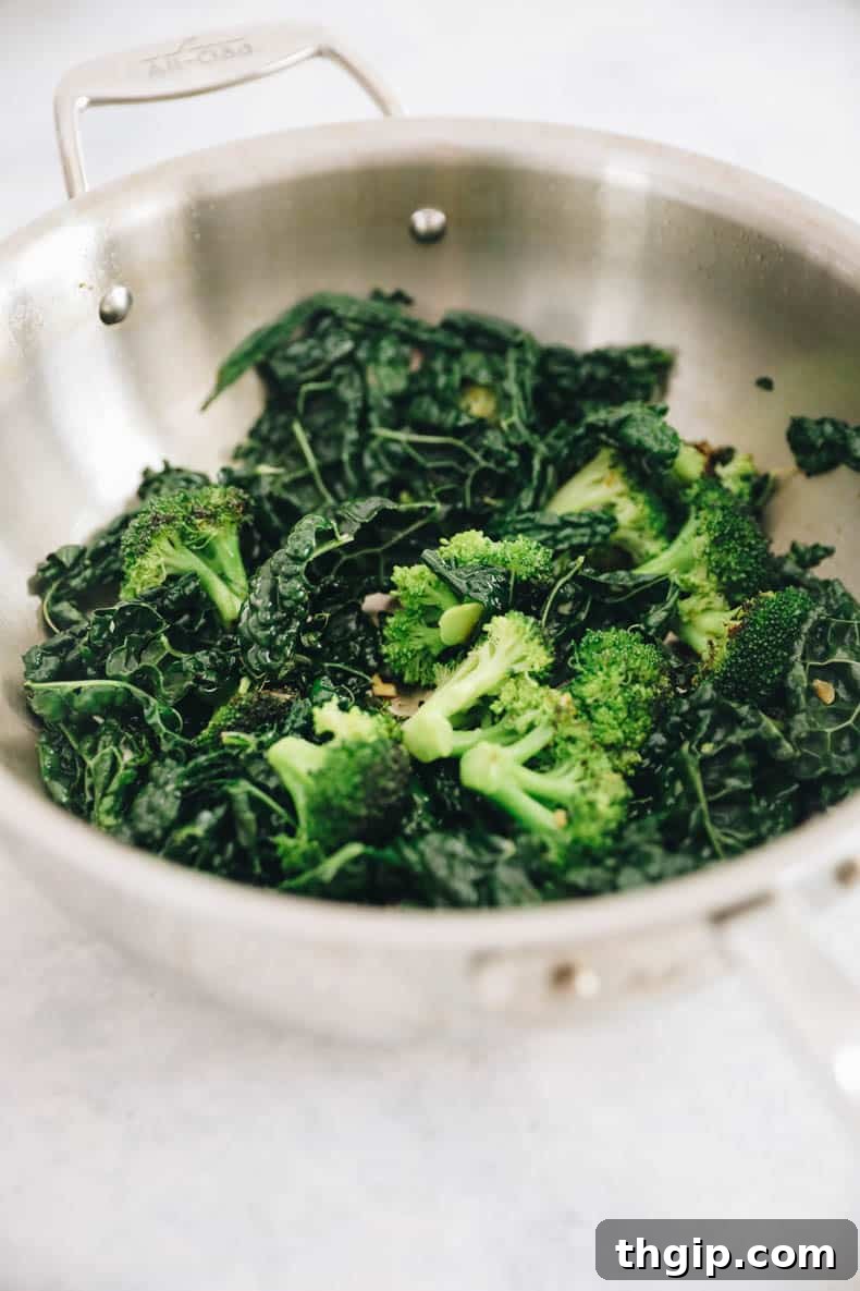 Steamed and sautéed broccoli and kale in a pot, cooked to perfection for Buddha Bowls.