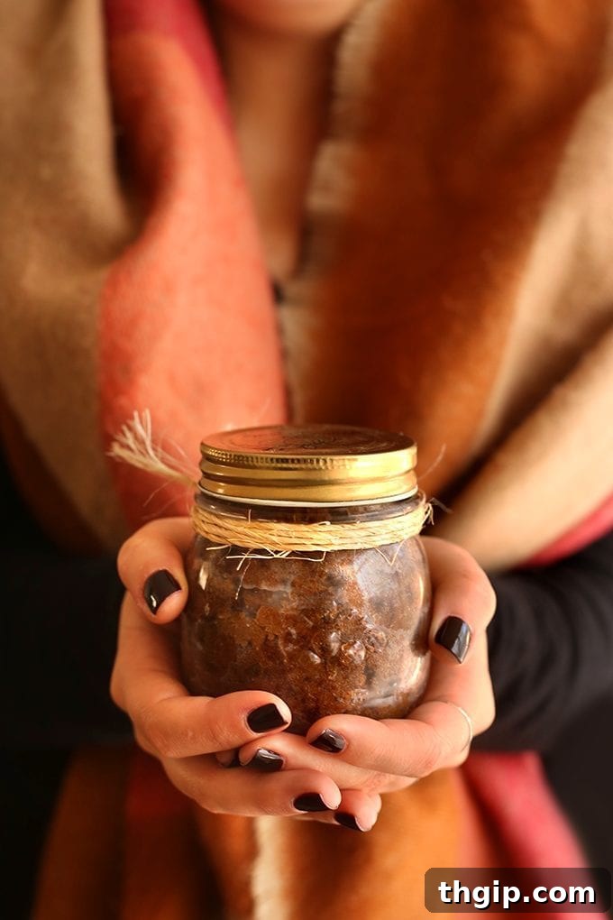 Sweet & Spicy Gingerbread Body Polish 3 Close-up of a DIY gingerbread body scrub in a glass jar, showcasing its rich texture and natural ingredients.