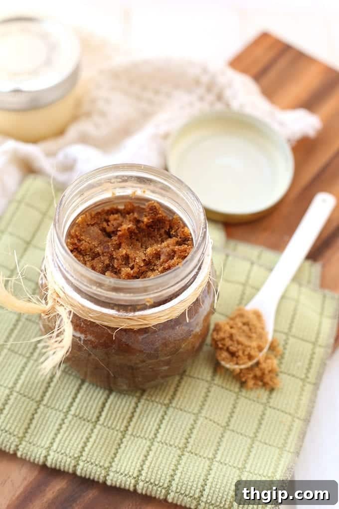 Sweet & Spicy Gingerbread Body Polish 4 Hand scooping out the natural gingerbread body scrub, highlighting its exfoliating texture.