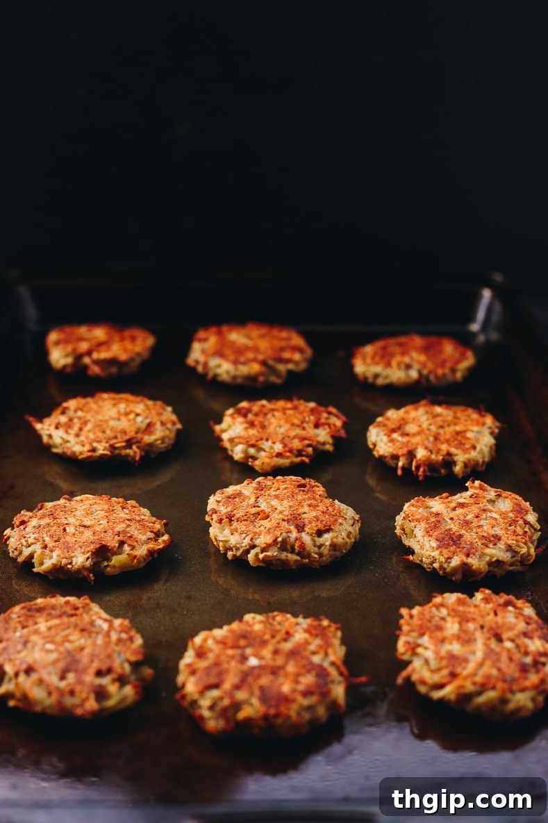 Crispy Baked Latkes Naturally Gluten Free and Vegan 3 Hands forming a latke patty from the potato mixture on a baking sheet, showcasing the preparation process.