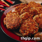Crispy golden baked latkes on a serving platter, ready to be enjoyed.